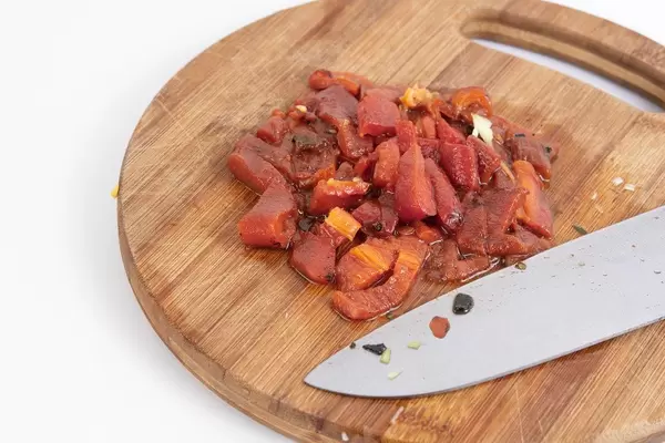 Sliced grilled red paprika on the wooden board