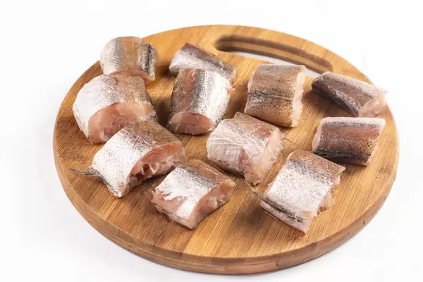 Sliced Hake Fish on the wooden board isolated on white background