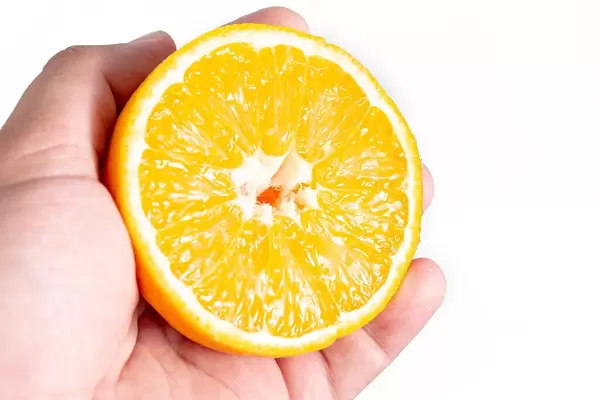 Sliced Half Orange fruit in the hand