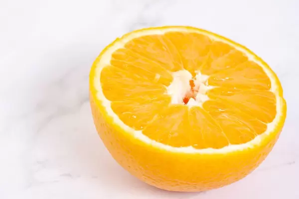 Sliced Half Orange fruit on the grey marble table
