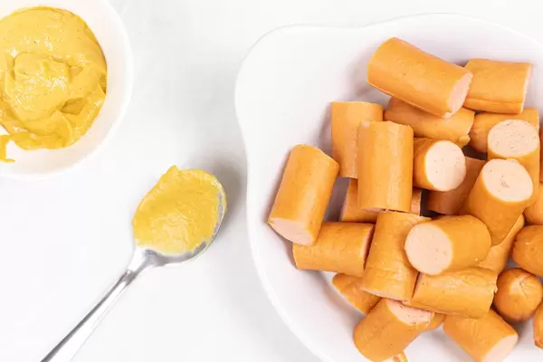 Sliced Hot Dog Sausages served with Mustard