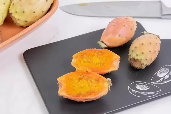 Sliced Indian Figs on the black tray with Tasty sign