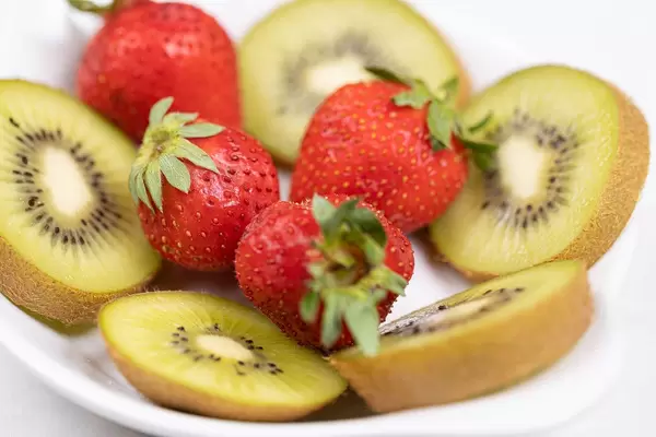 Sliced Kiwi and Strawberries served on the plate