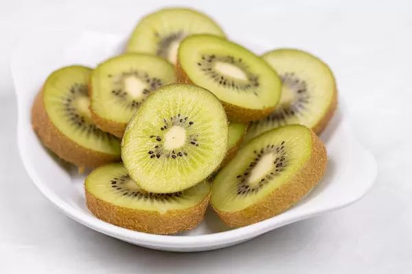 Sliced Kiwi served on the white plate