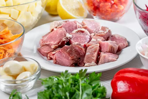 Sliced meat in the reflection of sliced and grated vegetables and greens. The concept of a recipe (Flip 2019)