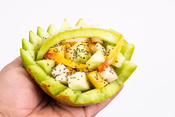 Sliced Melon and Peach with Chia seeds in the hand