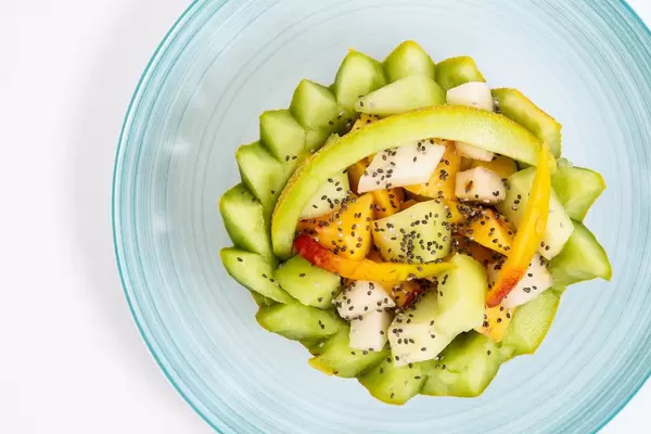 Sliced Melon and Peach with Chia seeds on the plate