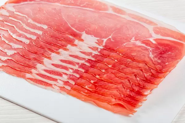 Sliced on the slicer dry-cured ham