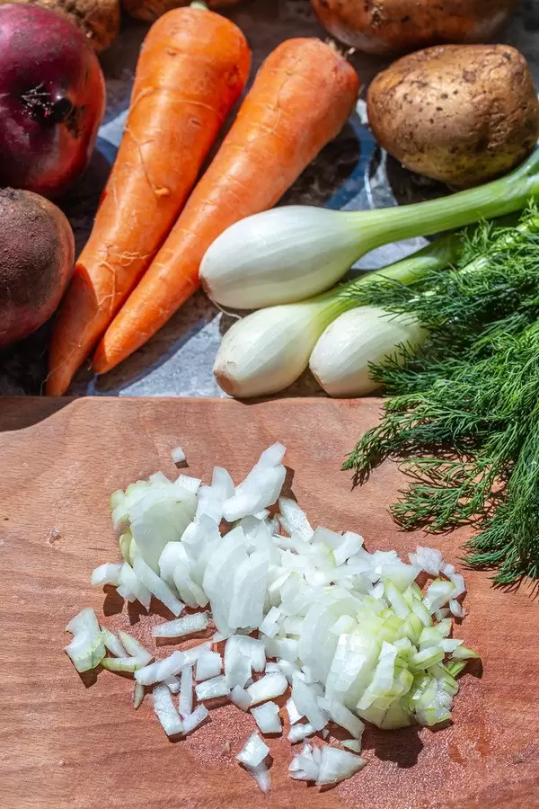 Sliced onion on kitchen Board with vegetables behind (Flip 2019)