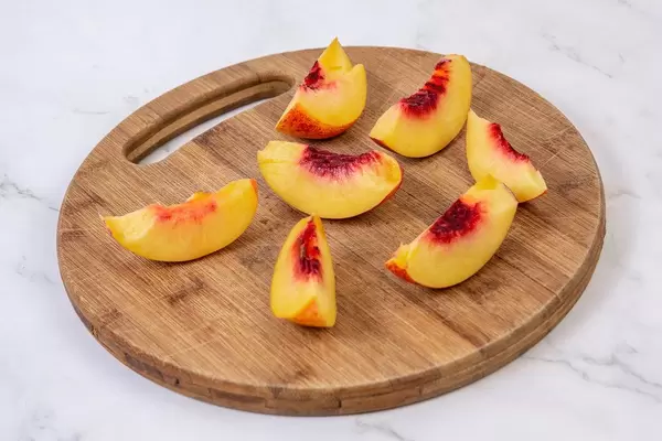 Sliced Peach on the round wooden board (Flip 2019)