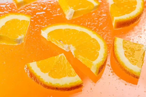 Sliced pieces of fresh orange with water drops
