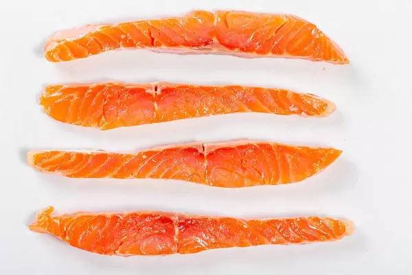 Sliced pieces of smoked red fish fillet