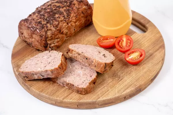 Sliced Pork and Chicken Meat Loaf with Tomatoes on the board (Flip 2019)