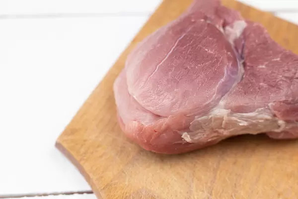 Sliced Pork Meat on the wooden board with copy space