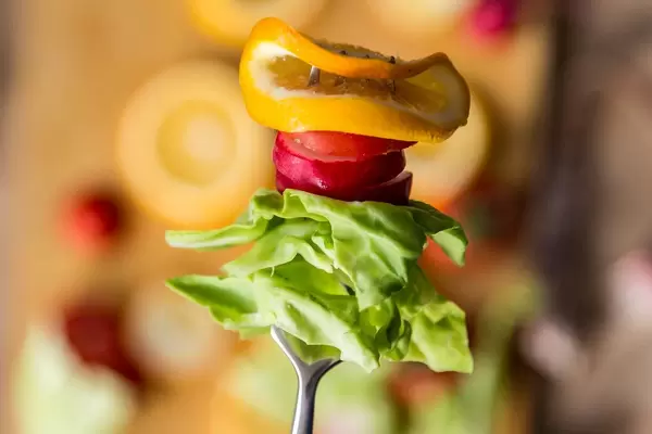 Sliced radish, cabbage, and lemon on the fork (Flip 2019)