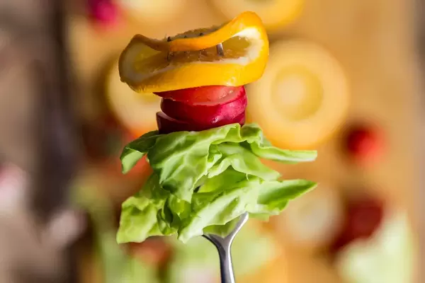 Sliced radish, cabbage, and lemon on the fork