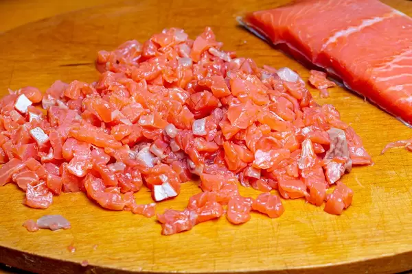 Sliced salmon fillet on a wooden kitchen Board (Flip 2020)
