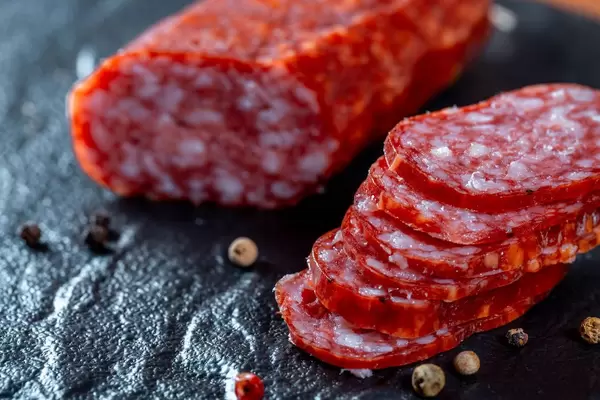 Sliced sausages on black