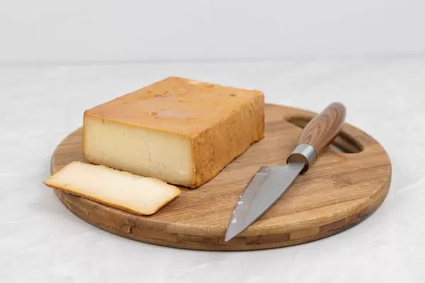Sliced Smoked Cheese on the wooden board