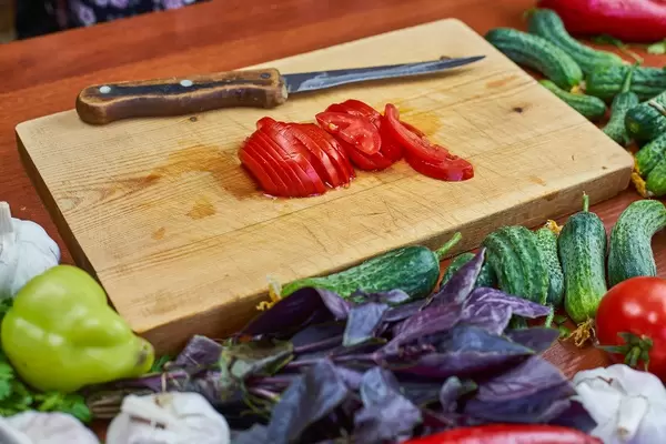 Sliced tomato on the wooden cutting board