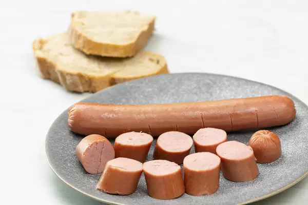 Sliced Wienerwurst on the plate with Bread