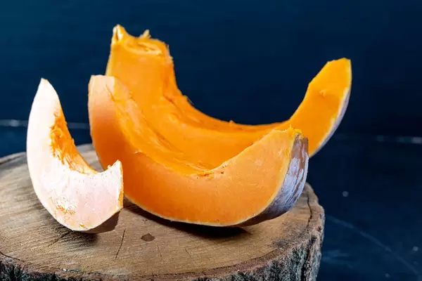 Slices of fresh pumpkin on dark background