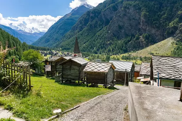 Small authentic Swiss wooden sheds on pillars in a valley village