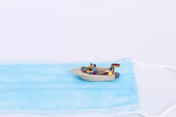 Small boat with German flag on medical face mask