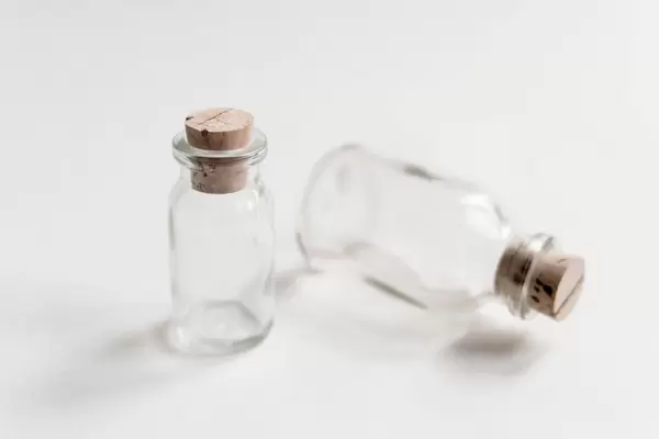 Small bottles with cork cap on white background