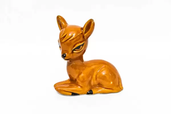 Small fawn figurine on white background (Flip 2019)