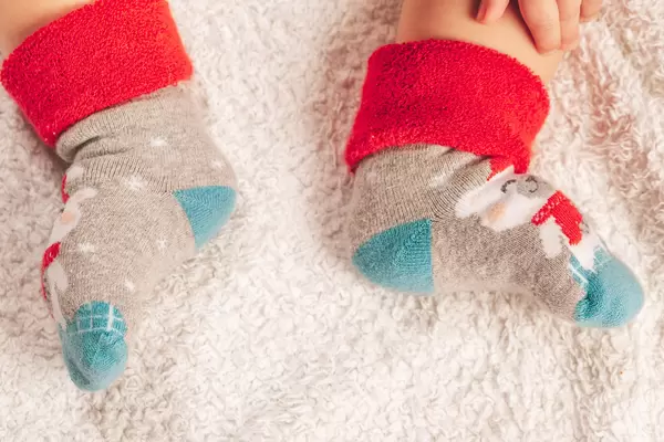 Small feet of a child in socks