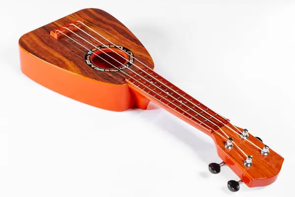 Small guitar (ukulele) on white background.