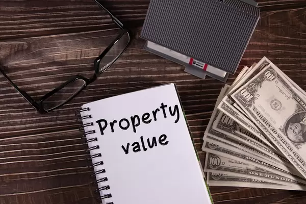 Small house with money and notebook with Property value text