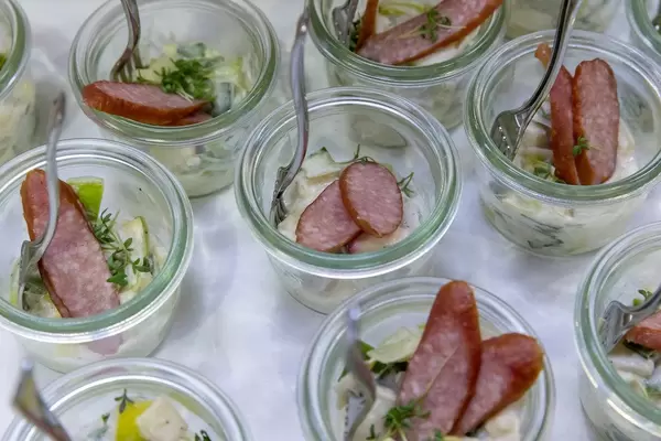 Small jars with Tyrolean smoked sausage on apple and leek salad at the BarCamp Bonn