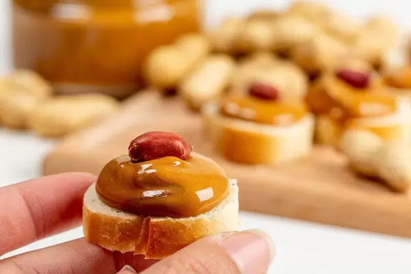 Small peanut butter sandwich in a woman's hand, close-up