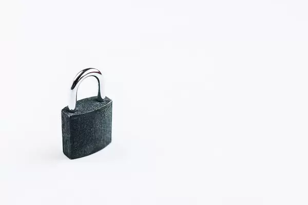 Small steel lock on white background