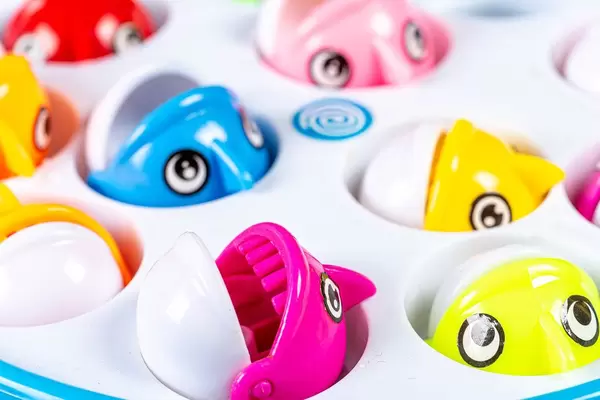 Small toy colorful fish in a plastic pool (Flip 2019)