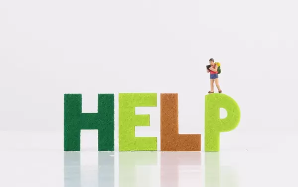 Small traveler figure with Help text on white background