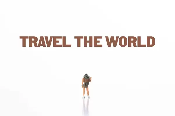 Small traveler with Travel The World text