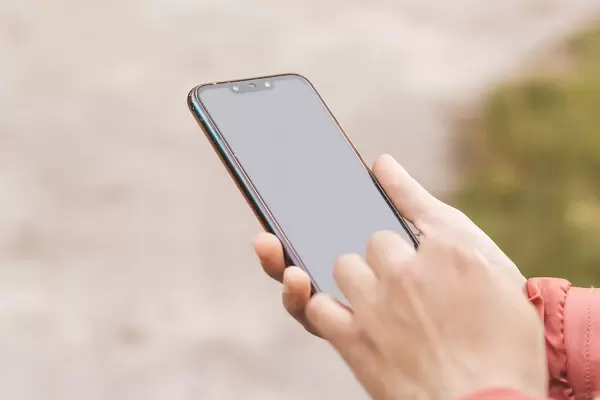 Smartphone in a woman's hand, the concept of modern communication