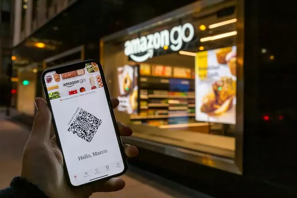 Smartphone with Amazon Go app in front of an Amazon Go store in Chicago