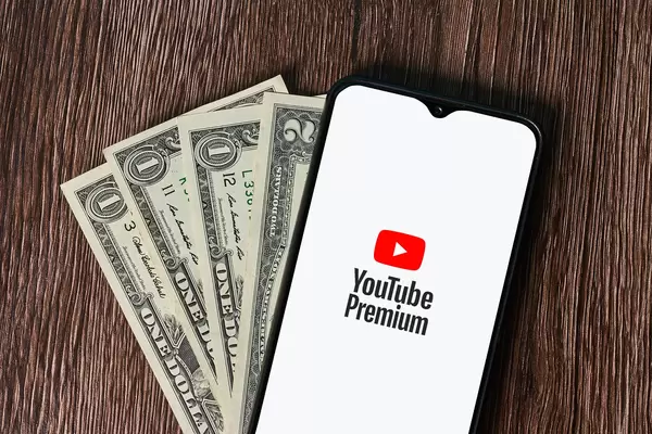 Smartphone with Youtube Premium service logo and us dollars