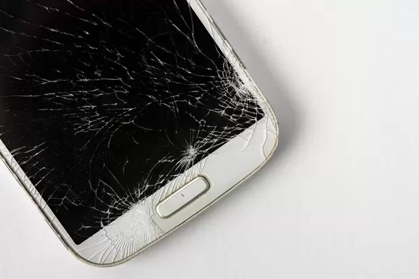 Smashed mobile phone on the table with copy space
