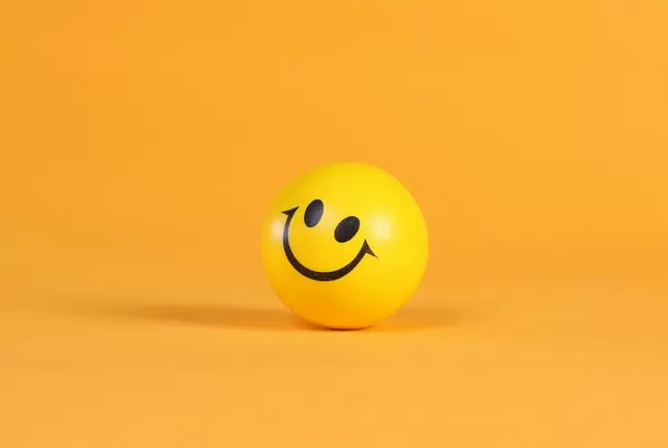 Smiley face on yellow ball