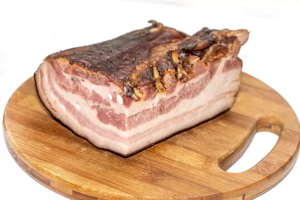 Smoked Bacon on the round wooden board