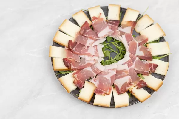 Smoked cheese with swiss ham served on the plate