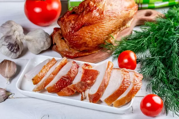Smoked chicken with vegetables and herbs on a white wooden table (Flip 2019)