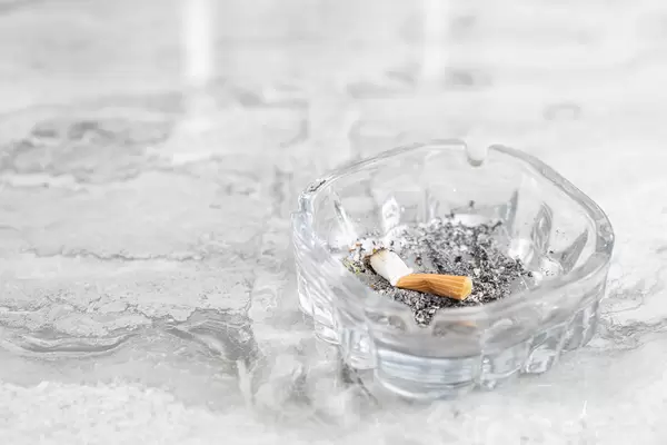 Smoked Cigarette in ashtray with copy space