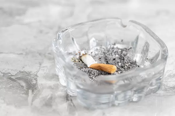 Smoked Cigarette with grey background