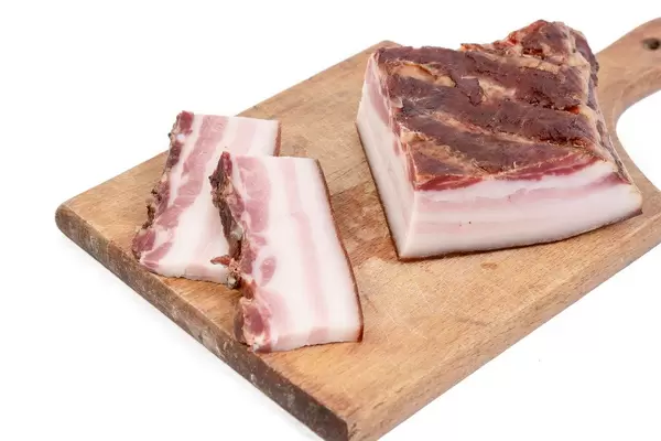 Smoked homemade bacon served on the wooden board